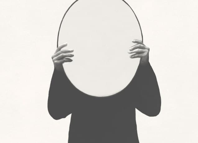 Illustration of person holding round shape mirror, alluding to zodiac mirror theory.