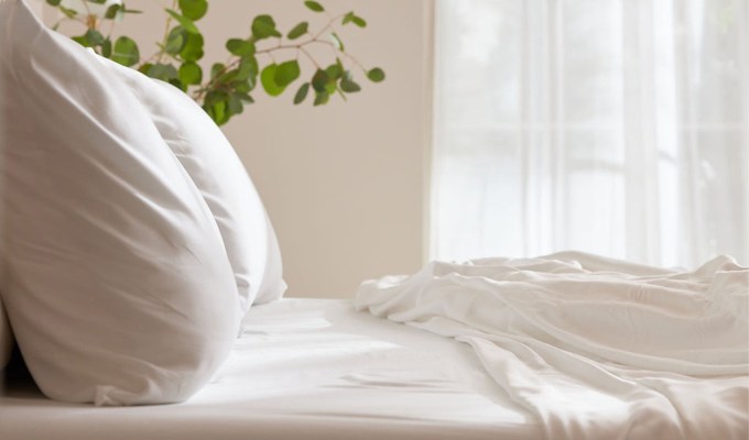 A bed made up with Cozy Earth bedding.