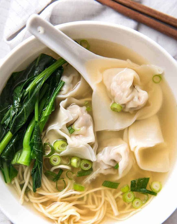 traditional chinese new year foods: wonton soup with greens